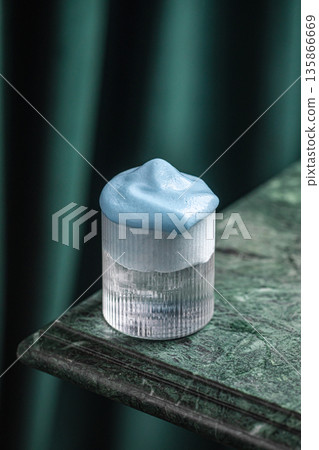 Cocktail with whipped blue foam in ribbed glass 135866669
