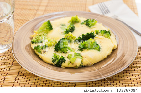 wholesome breakfast. omelet with broccoli on brown plate 135867084