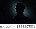 Silhouette Portrait in Backlit Darkness From Behind with Subtle Halo Glow 135867551