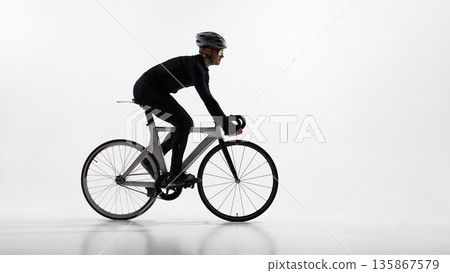 Professional cyclist riding road bike in studio isolated on white background. 135867579