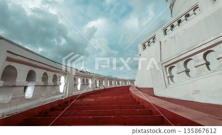 Stairs leading up to sky with dramatic clouds, Way to heaven or paradise concept, Red staircase ascending toward new life and beginning of hope 135867612