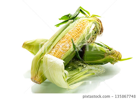 juicy ripe corn cob in husk on white background 135867748
