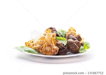 Roasted vegetables with cauliflower and mushrooms in warm tones Roasted vegetables with cauliflower and mushrooms in warm tones 135867752