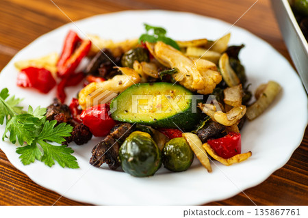Organic roasted vegetables served with herbs and seasoning 135867761