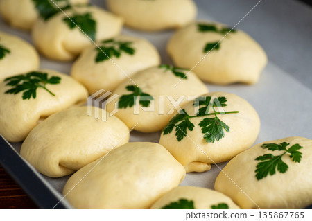 Homemade yeast dough rolls with parsley before baking 135867765