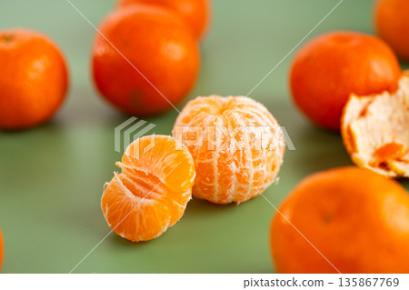 Sweet ripe citrus fruits displayed with scattered aromatic peel Sweet ripe citrus fruits displayed with scattered aromatic peel 135867769