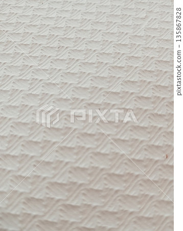 White embossed paper texture with geometric pattern close up 135867828