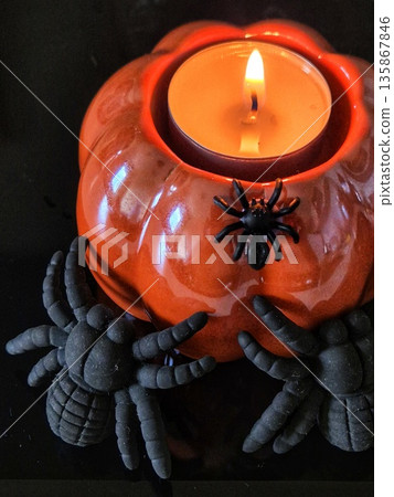 halloween pumpkin candle holder with spider. spooky pumpkin candlelight. 135867846
