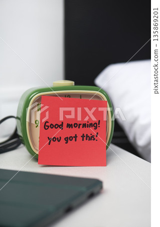 a morning message attached to an alarm clock 135869201