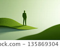 Silhouette of a Man Standing on Green Rolling Hills in a Surreal Landscape 135869304