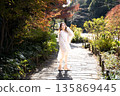 Woman in autumn park 135869445