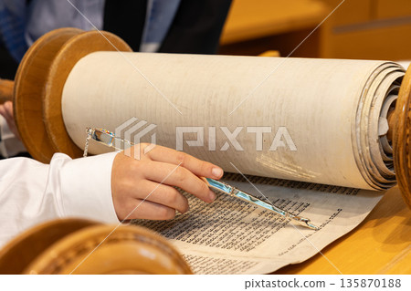 Hand of boy reading the Jewish Torah at Bar Mitzvah Hand of boy reading the Jewish Torah at Bar Mitzvah 135870188