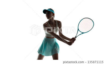 Professional female tennis player mid swing isolated on white background. 135871115