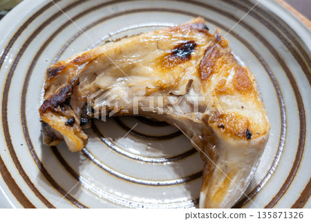 Fragrant salted fish served on a plate 135871326