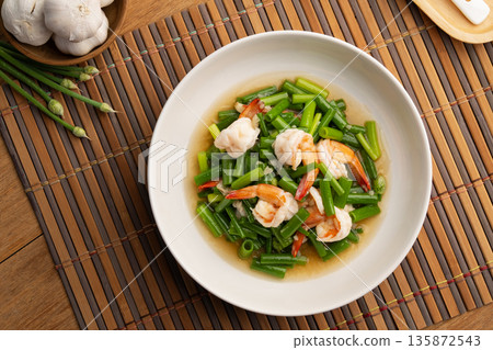 Stir Fried Onion Flower Stem with Shrimp and oyster sauce in white plate. Stir Fried Onion Flower Stem with Shrimp and oyster sauce in white plate. 135872543