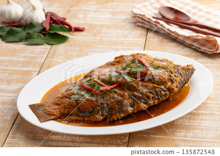 Tilapia Fish with red curry sauce,Thai Chu Chee Fish Curry in a plate. Tilapia Fish with red curry sauce,Thai Chu Chee Fish Curry in a plate. 135872548