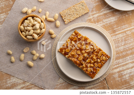 Chinese Peanut and Sesame Bar,Peanut brittle crisp candy in a plate.Thai snack.Top view. Chinese Peanut and Sesame Bar,Peanut brittle crisp candy in a plate.Thai snack.Top view. 135872557