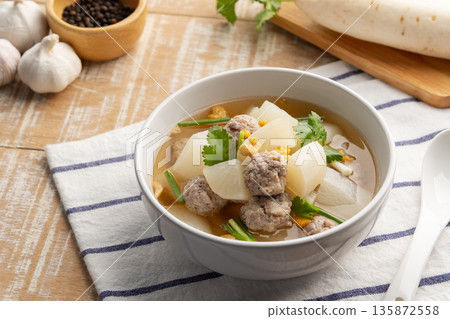 Clear Soup with White Radish and minced pork ball in white bowl.Thai food. Clear Soup with White Radish and minced pork ball in white bowl.Thai food. 135872558