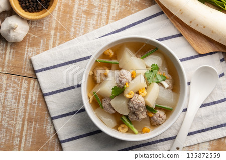 Clear Soup with White Radish and minced pork ball in white bowl.Thai food.Top view. Clear Soup with White Radish and minced pork ball in white bowl.Thai food.Top view. 135872559