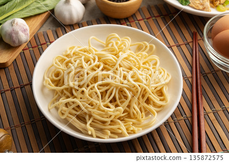 Raw yakisoba noodles in white plate,made from wheat flour and egg. 135872575