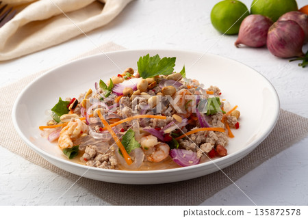 Spicy Glass Seaweed noodle Salad with Minced Pork (yum sen kaew) is a type of Thai salad made with clear Kelp noodle and meat in white plate 135872578
