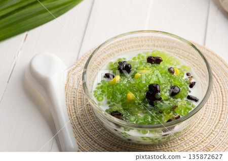 Pandan flavoured Black bean and corn Tapioca pearl pudding (Sago) with a dash of coconut milk Pandan flavoured Black bean and corn Tapioca pearl pudding (Sago) with a dash of coconut milk 135872627