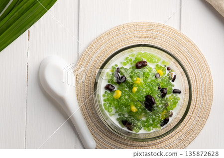 Pandan flavoured Black bean and corn Tapioca pearl pudding (Sago) with a dash of coconut milk 135872628