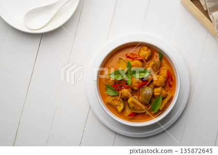 Red curry with clown featherback fishball in white bowl (Gaeng Kua Look Chin pla).Top view Red curry with clown featherback fishball in white bowl (Gaeng Kua Look Chin pla).Top view 135872645