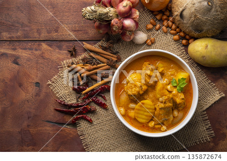 Massaman Curry with Chicken and Potatoes.It is an aromatic curry with a tangy, luxurious taste that is harmonic, sweet and isn't as spicy.Top view Massaman Curry with Chicken and Potatoes.It is an aromatic curry with a tangy, luxurious taste that is harmonic, sweet and isn't as spicy.Top view 135872674