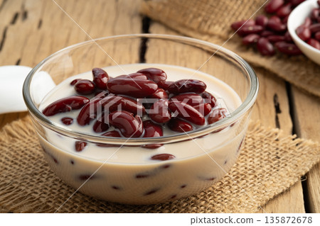 Boiled red beans in coconut milk and sugar in glass bowl,Thai Dessert on wooden table 135872678