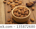 Dry roasted Almonds in wooden bowl on wooden table.Heap of almond. 135872680