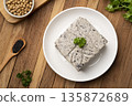 Tofu mix black sesame seeds in white plate on wooden table.Top view 135872689