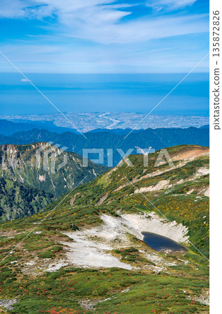 View of the Kurobe alluvial fan and Kurobe River from the border of the three countries. Traverse hike from Mt. Shirouma to Mt. Yukikura in the Northern Alps. View of the Kurobe alluvial fan and Kurobe River from the border of the three countries. Traverse hike from Mt. Shirouma to Mt. Yukikura in the Northern Alps. 135872826