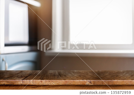 Wooden kitchen table with blurred home interior background 135872959