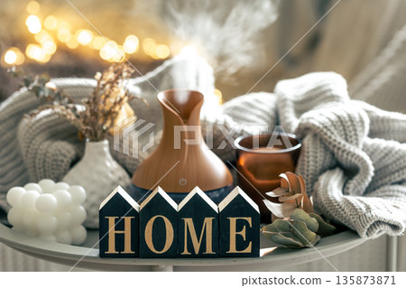 Aroma composition with a modern aroma oil diffuser, candles and a knitted element. Aroma composition with a modern aroma oil diffuser, candles and a knitted element. 135873871