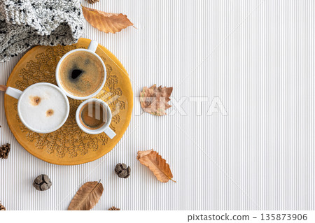 Autumn composition with cups of coffee and leaves on a white background. 135873906