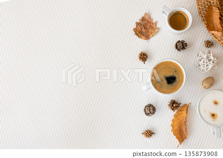 Autumn composition with cups of coffee and leaves on a white background. 135873908