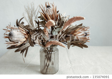 Arrangement of dried flowers in a glass vase close up. Arrangement of dried flowers in a glass vase close up. 135874091