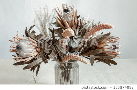Arrangement of dried flowers in a glass vase close up. 135874092
