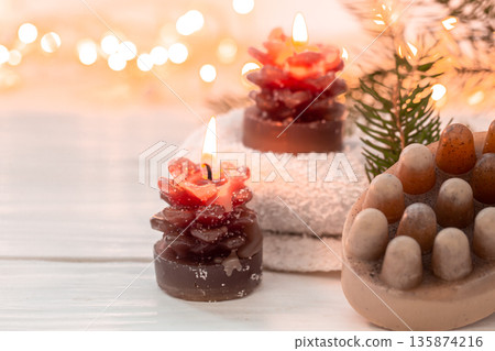 Christmas spa composition with incense sticks and soap on a blurred background. 135874216