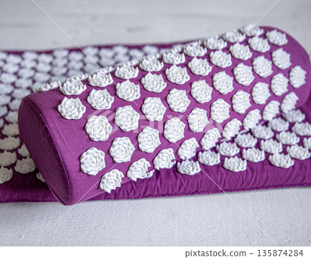 Massage acupuncture mat with pillow and white massage tips. Massage acupuncture mat with pillow and white massage tips. 135874284
