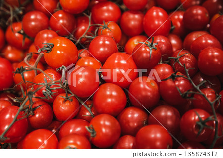 Close-up, small red tomatoes on the supermarket counter. 135874312