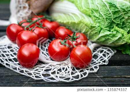 Close-up of tomatoes on a wooden surface. 135874337