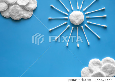 Clouds and sun made of cotton swabs and cotton discs. Clouds and sun made of cotton swabs and cotton discs. 135874362