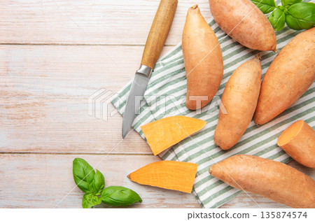 Preparing raw sweet potatoes for healthy cooking 135874574