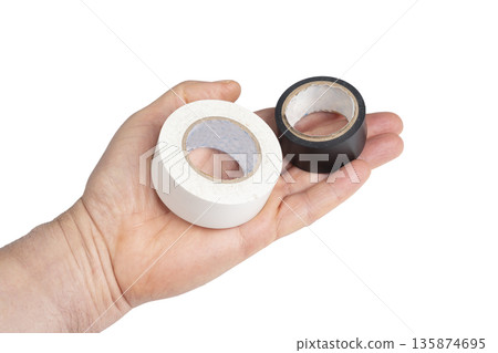 a roll of white and black electrical tape on the palm of your hand a roll of white and black electrical tape on the palm of your hand 135874695