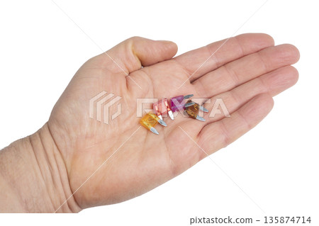 some car fuses in the palm of your hand 135874714
