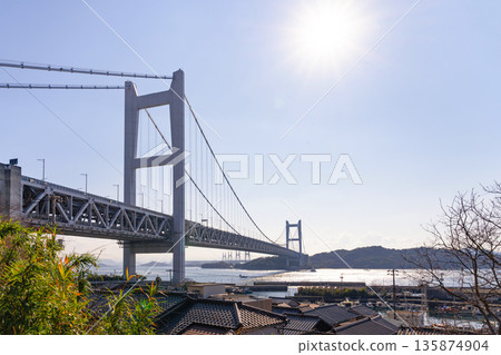 Kurashiki City, Okayama Prefecture: The Seto Ohashi Bridge and the Tanoura townscape as seen from Tadoura Shrine Kurashiki City, Okayama Prefecture: The Seto Ohashi Bridge and the Tanoura townscape as seen from Tadoura Shrine 135874904