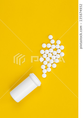 Scattered tablets on a yellow background, flat layout. 135874932