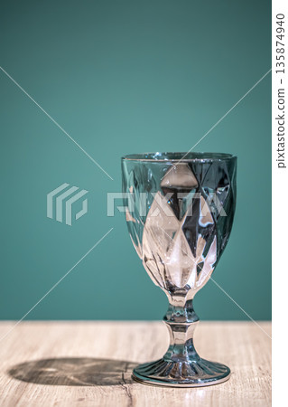 Shiny textured glass on a light blue background. Shiny textured glass on a light blue background. 135874940